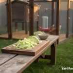 A clean cutting board with chopped cabbage and a small bowl, next to a coop run door.